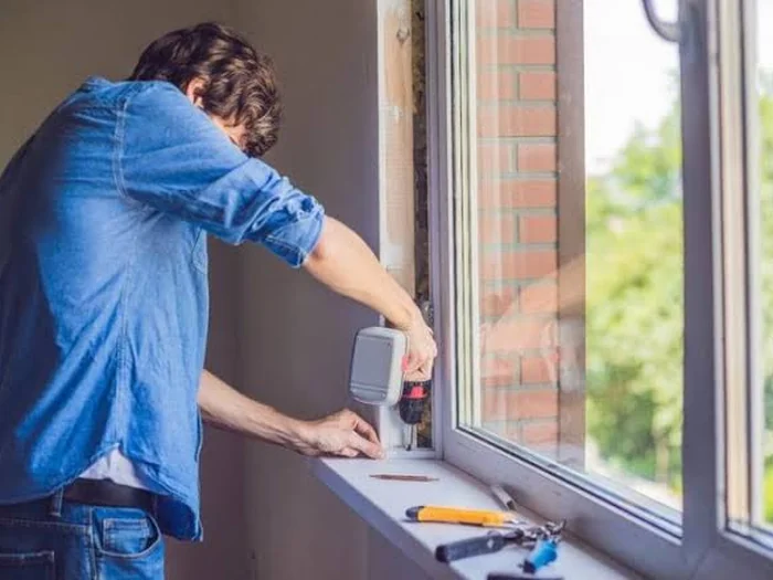 Specialist adjusting a sliding door mechanism — Sliding Door Repair UK